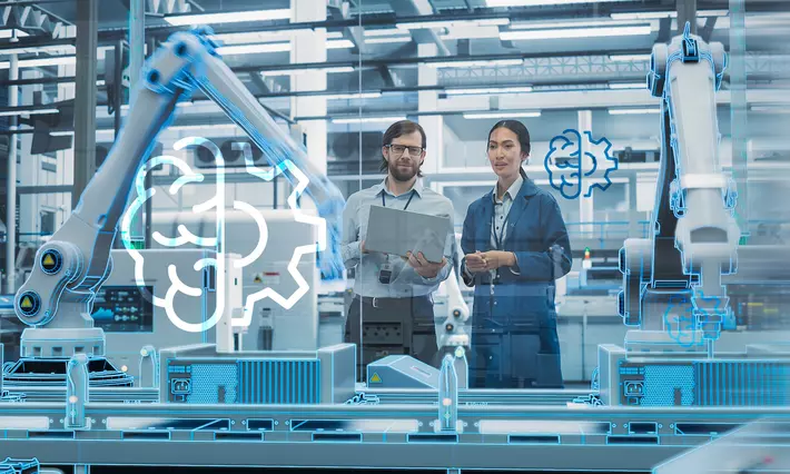 Man and woman in automation production with robots