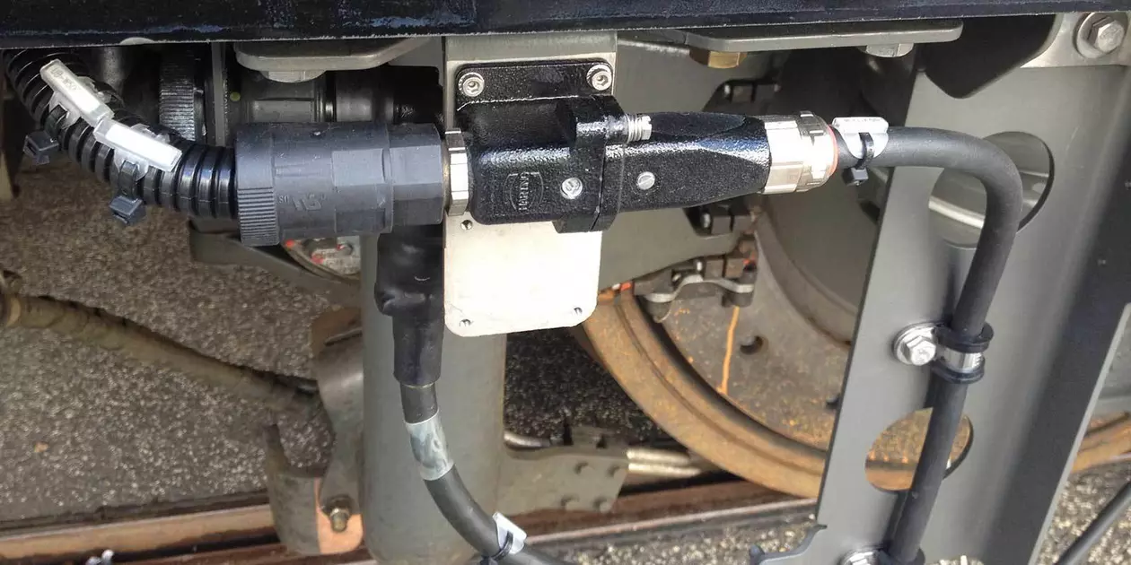 Axle sensor cabling on a wheel axle is used to monitor the speed of the train.